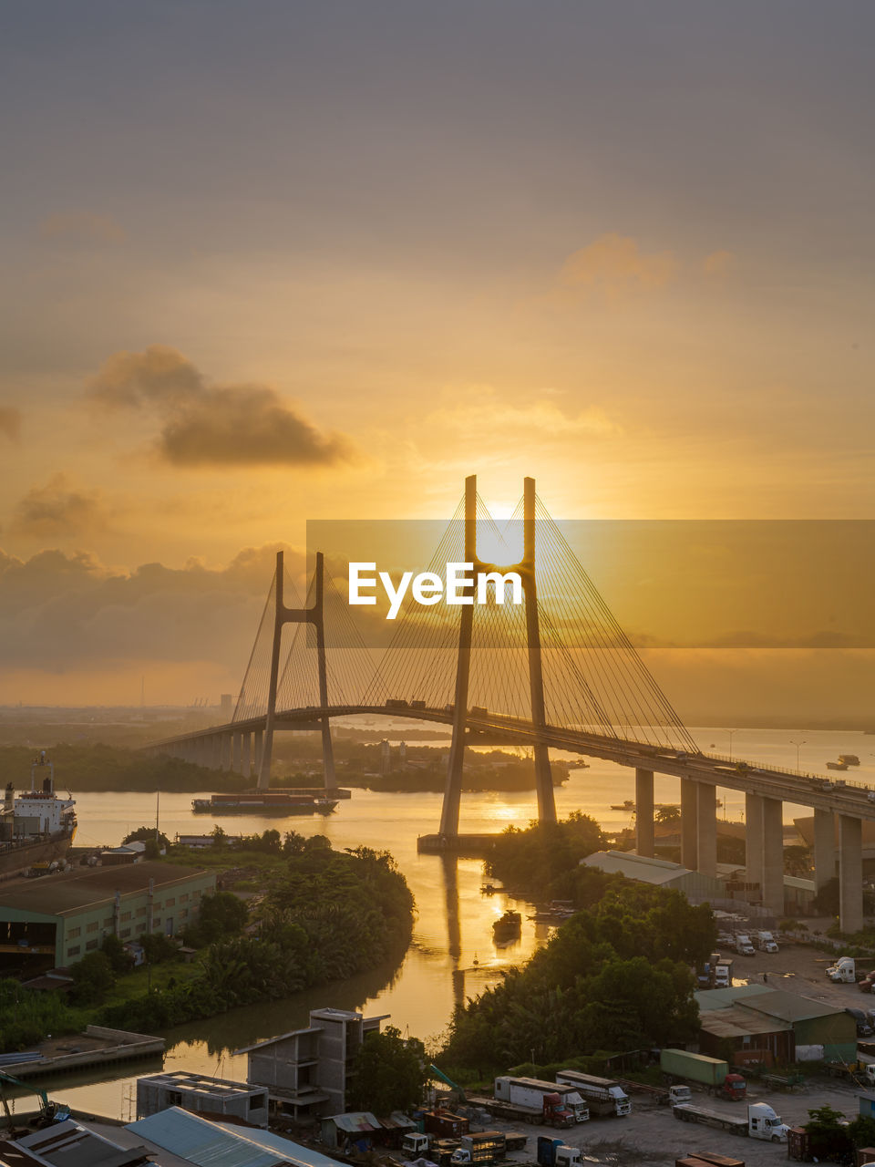 VIEW OF SUSPENSION BRIDGE AGAINST SKY DURING SUNSET