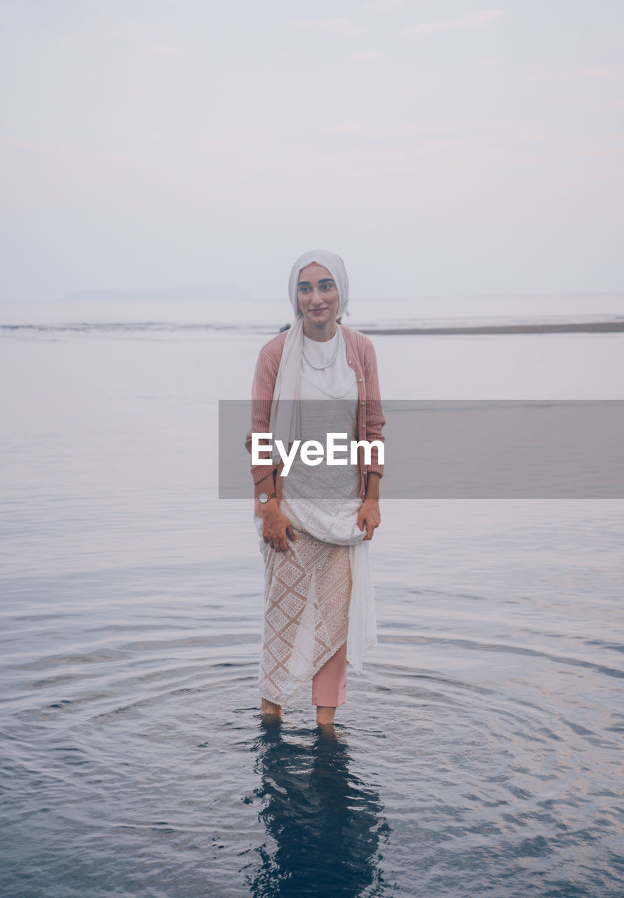 FULL LENGTH OF MAN STANDING IN SEA