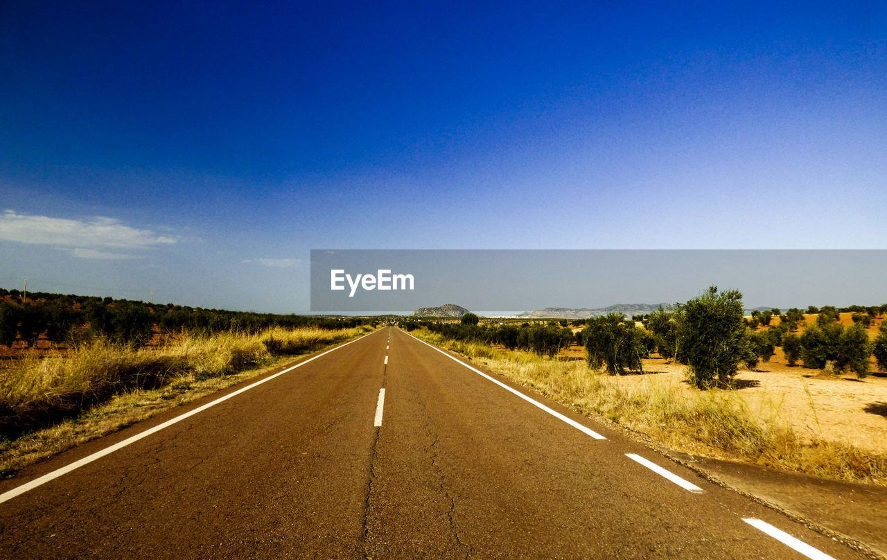 Empty road along landscape