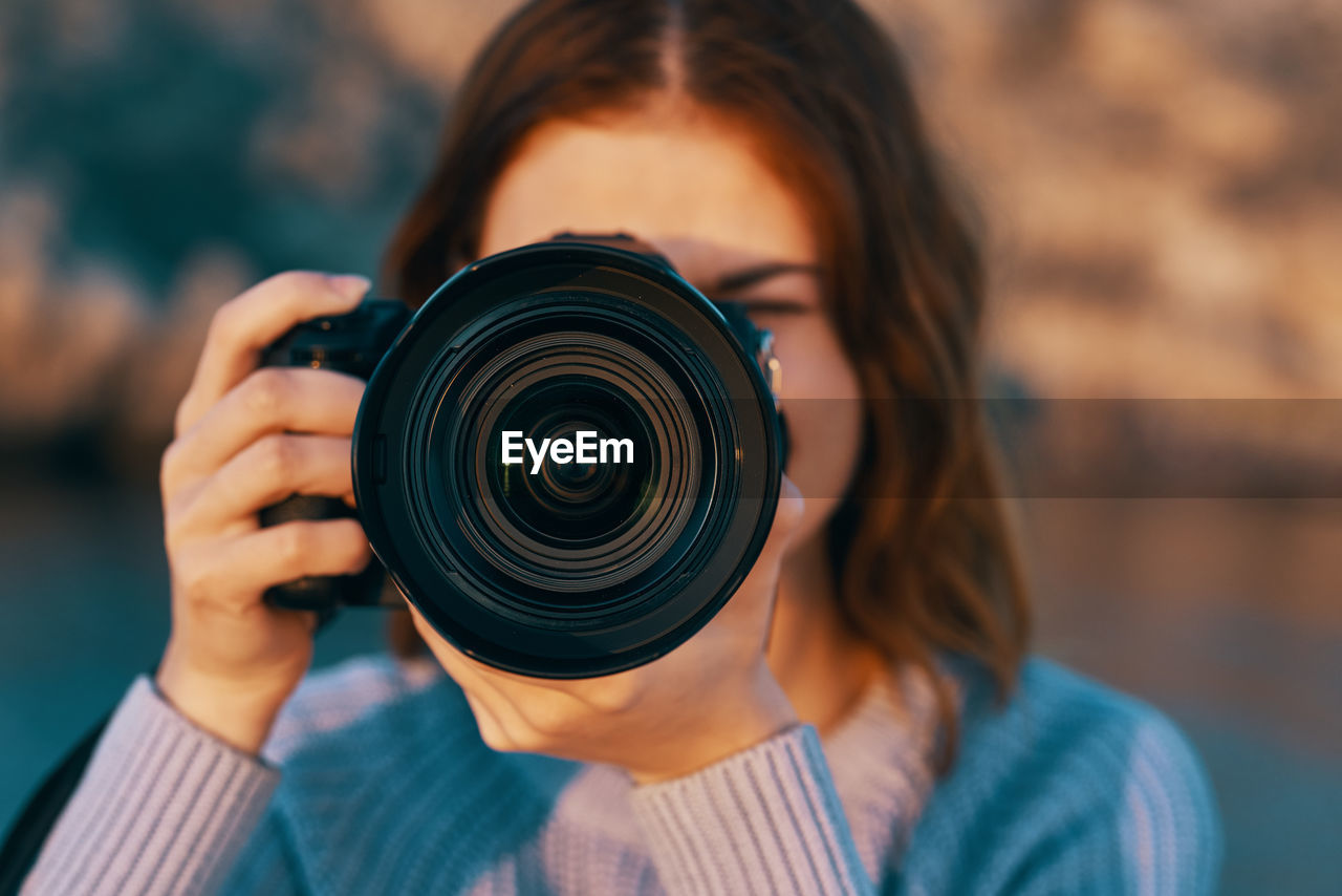 Portrait of woman photographing