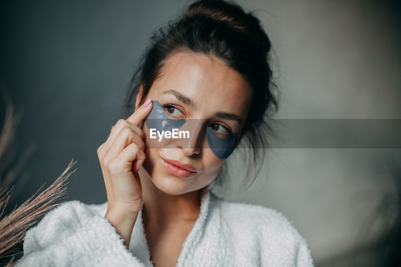 Portrait of a 30 year old woman with patches on her face