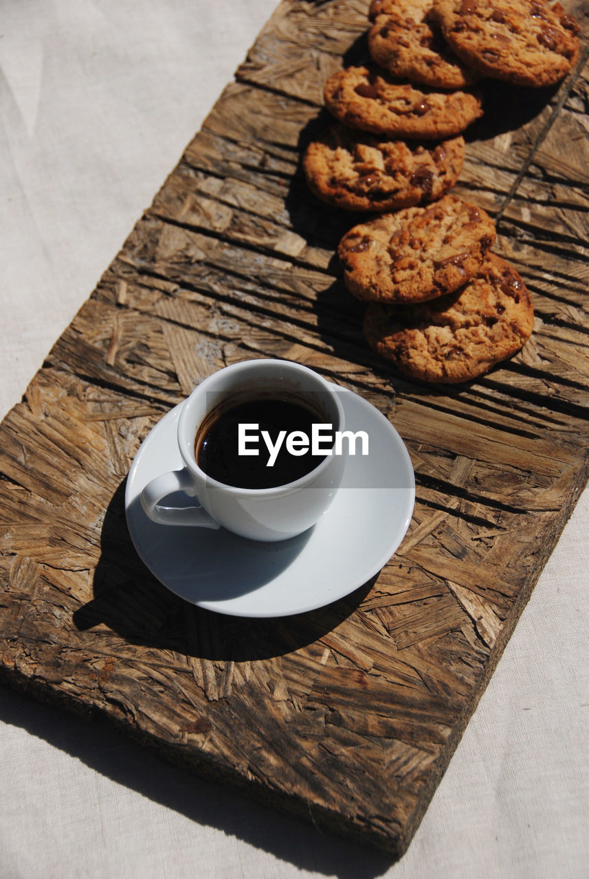High angle view of coffee and cookies on table