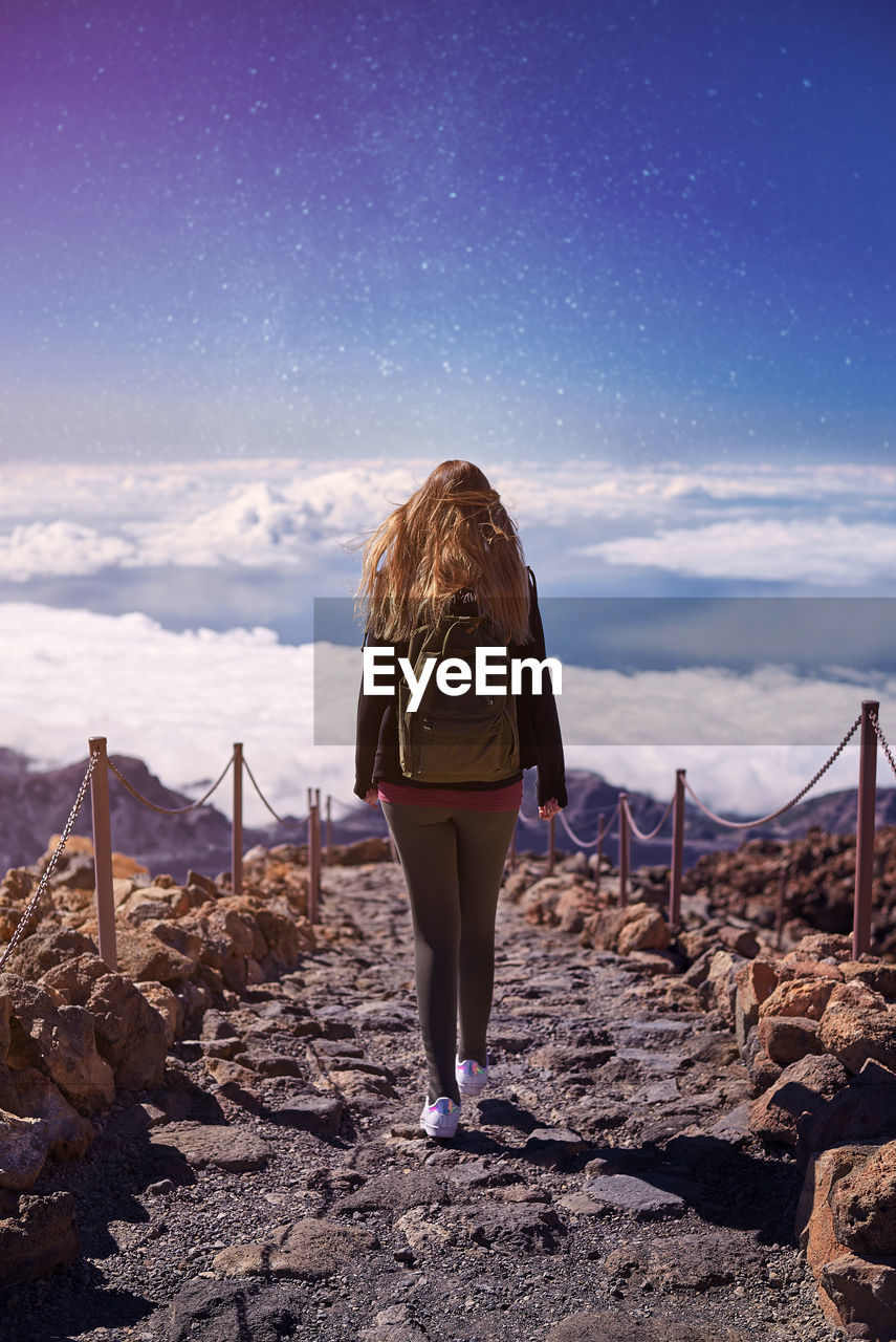 Rear view of woman walking at teide