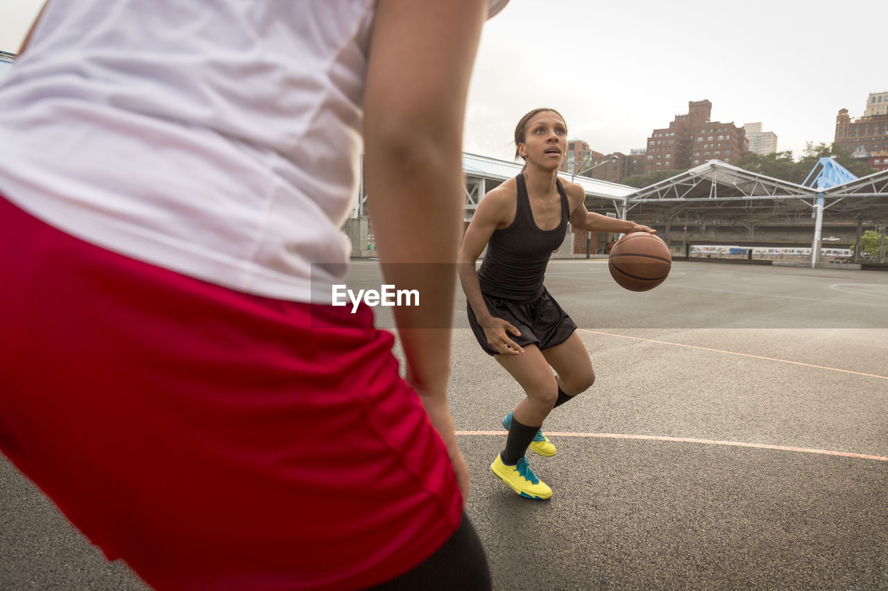 Basketball players playing in court