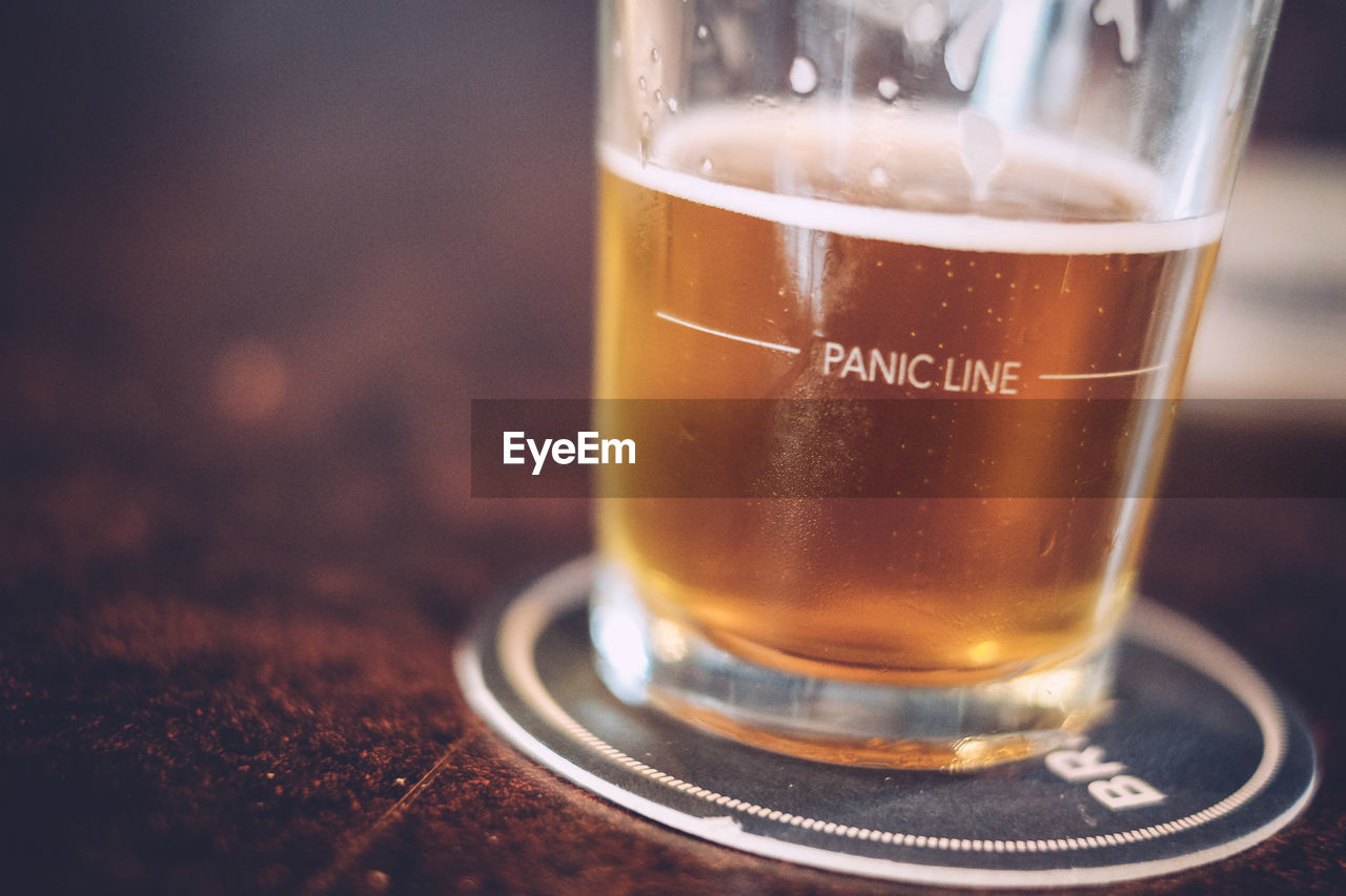 Close-up of beer served on table