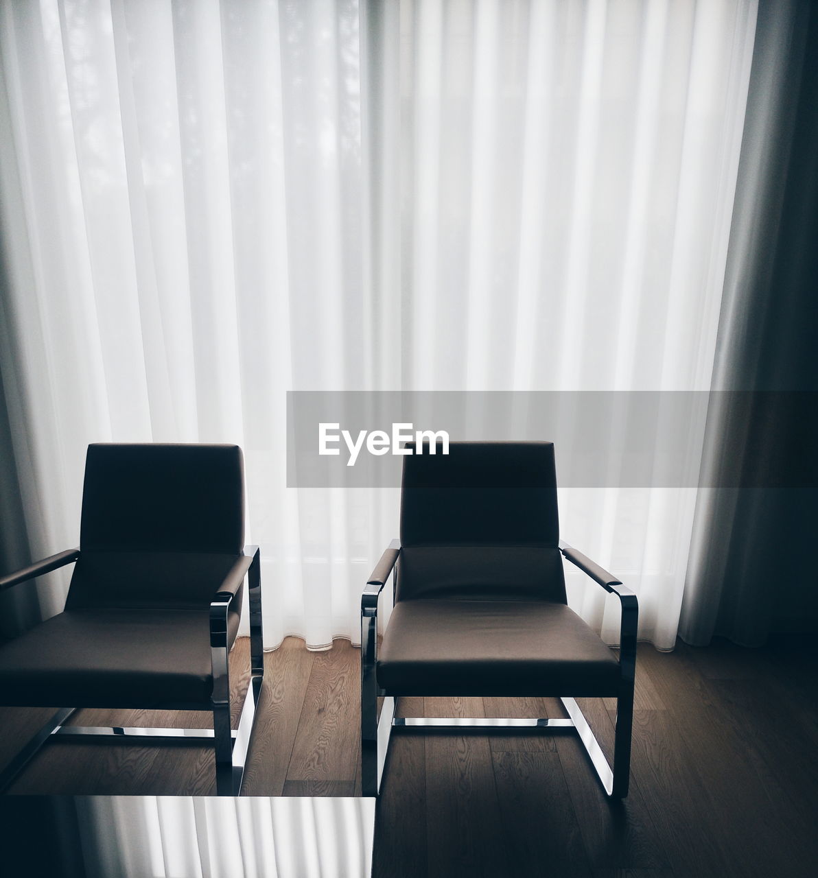 High angle view of empty chairs on floor against curtains