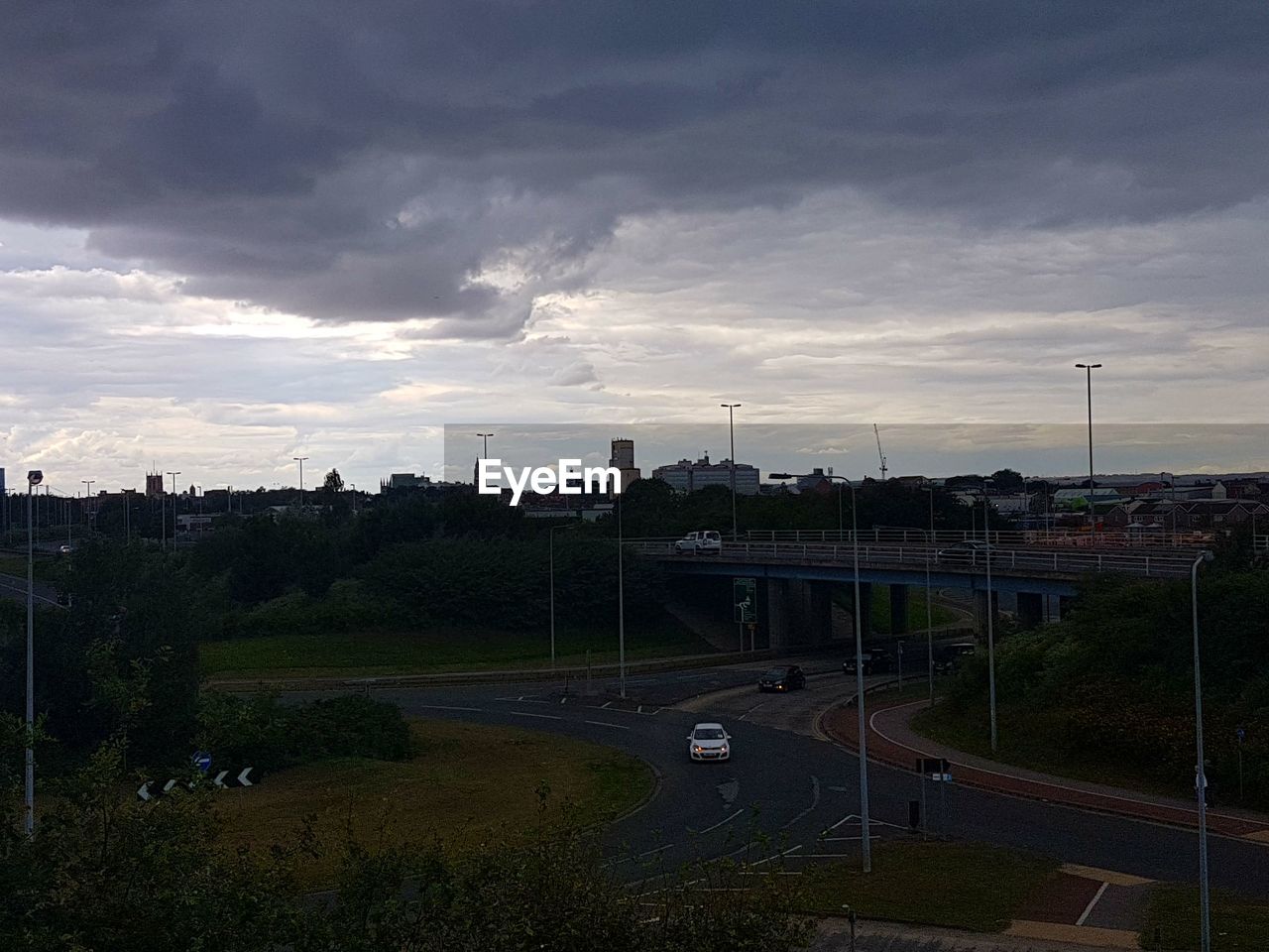 VIEW OF ROAD AGAINST CLOUDY SKY