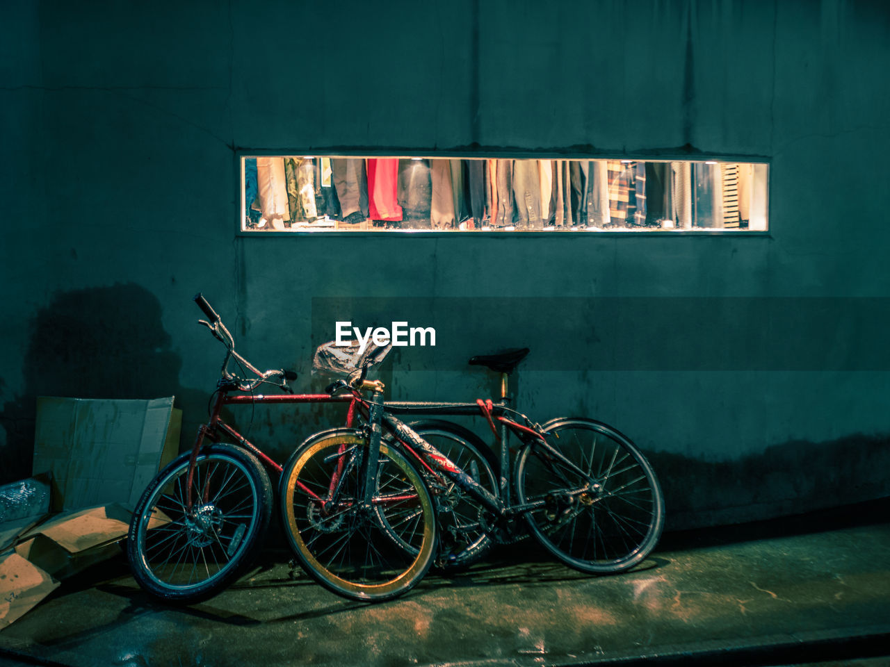 BICYCLE PARKED AGAINST BUILDING