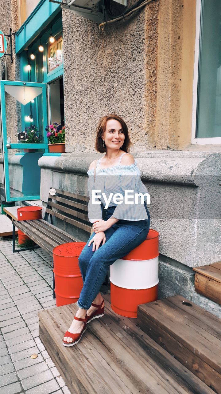 Portrait of a smiling woman sitting outdoors