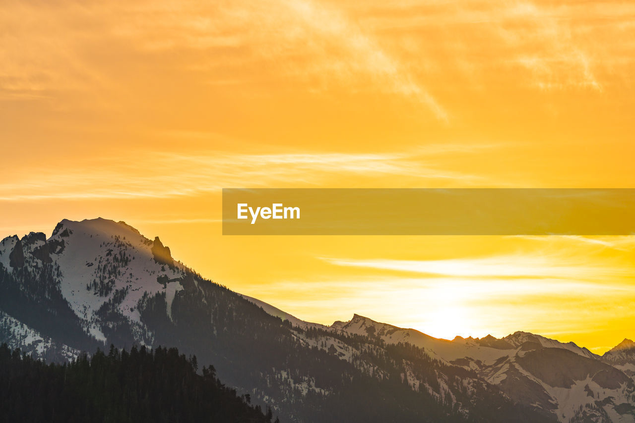 SCENIC VIEW OF SNOWCAPPED MOUNTAINS DURING SUNSET