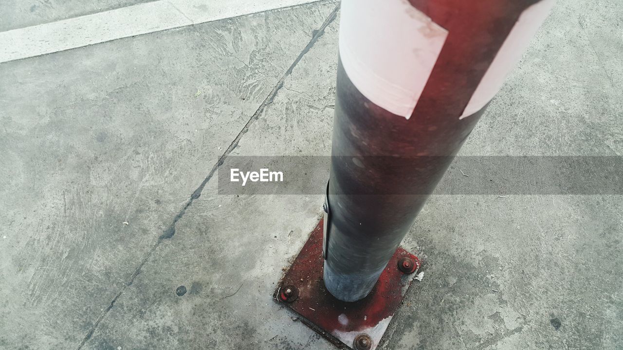 HIGH ANGLE VIEW OF RED WINE ON ROAD