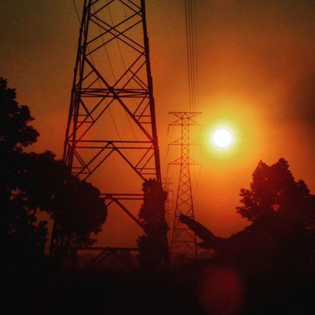 LOW ANGLE VIEW OF ELECTRICITY PYLON AT SUNSET