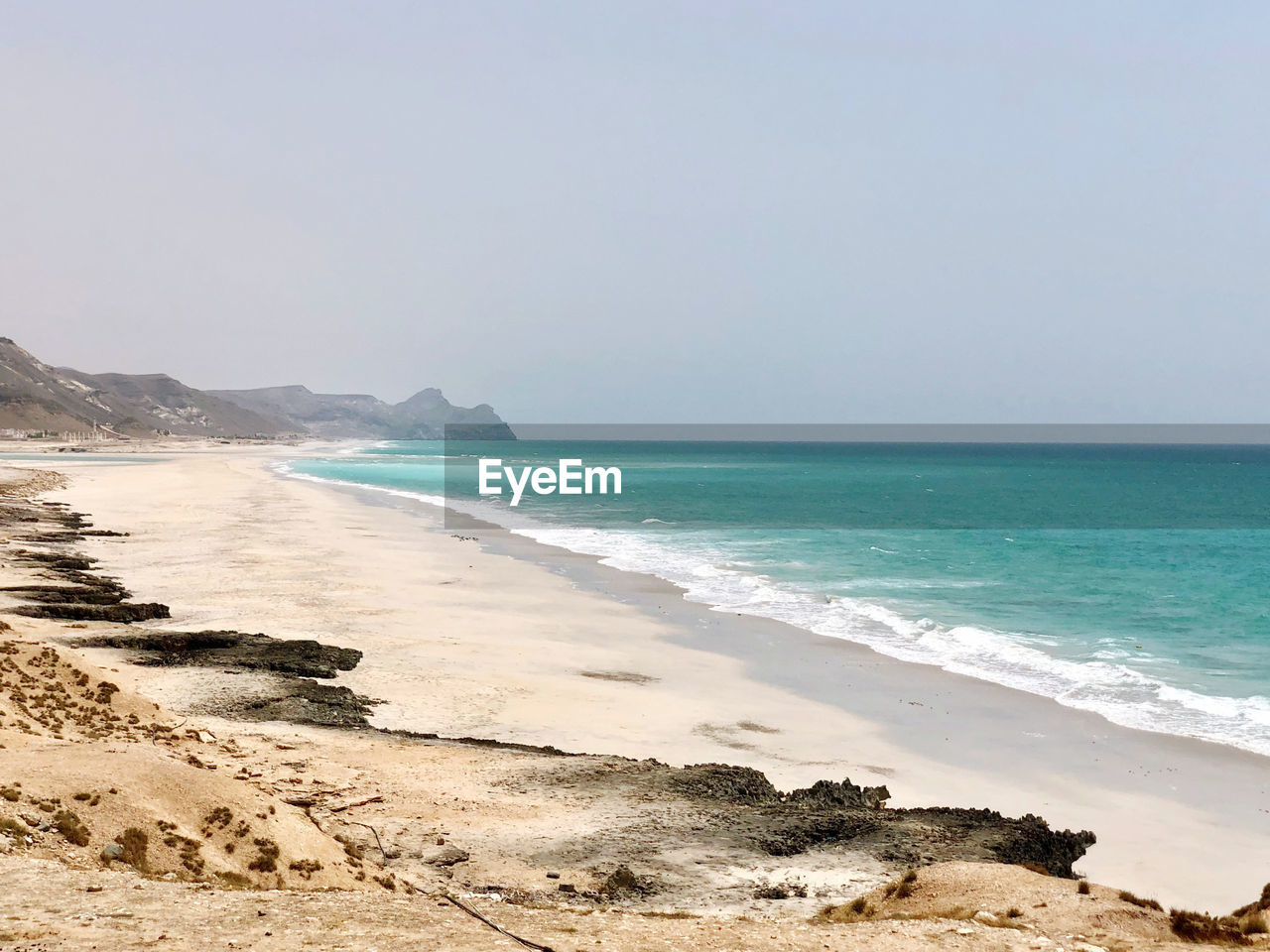 Scenic view of beach against clear sky