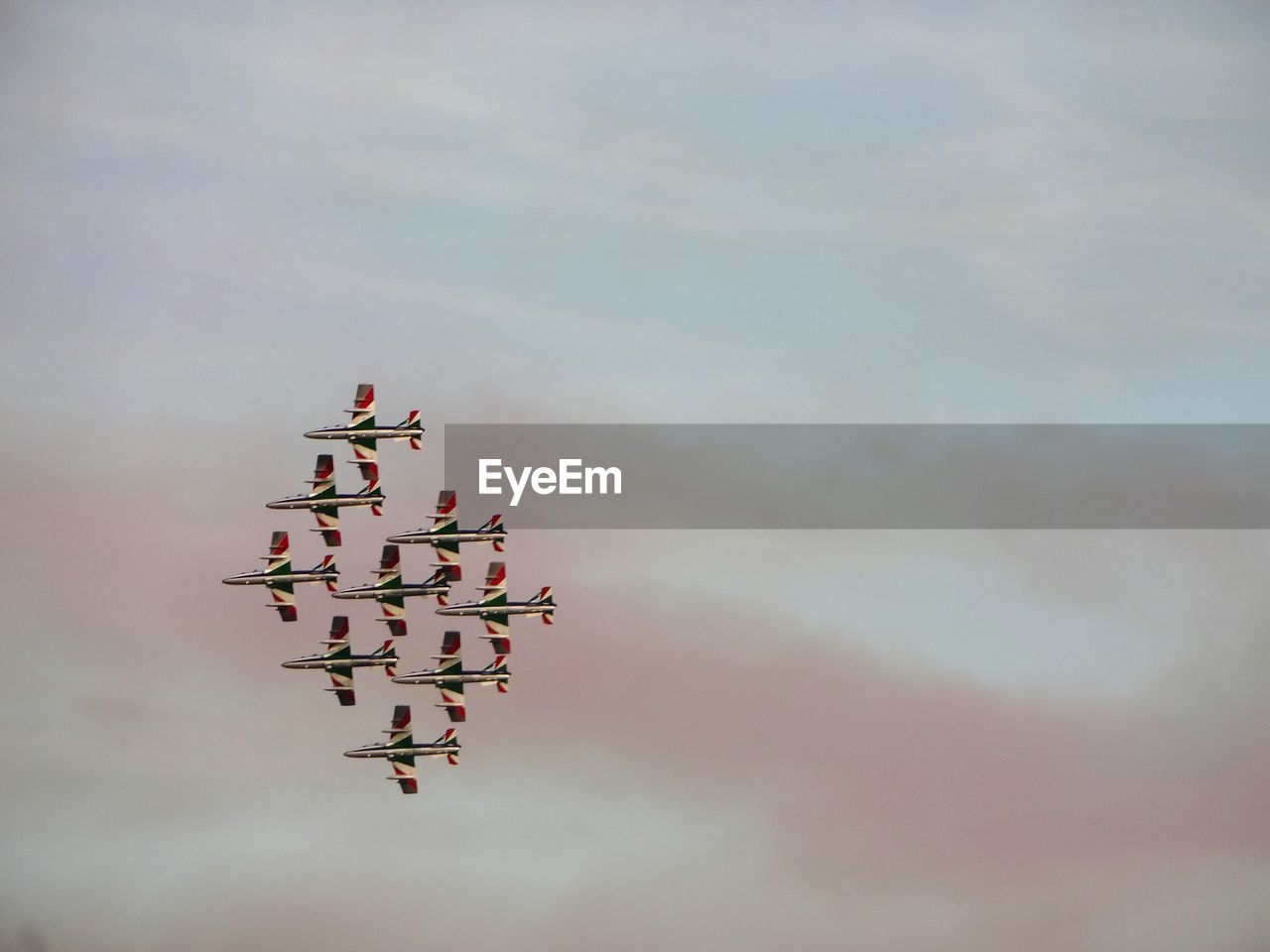 Low angle view of airplanes flying against sky