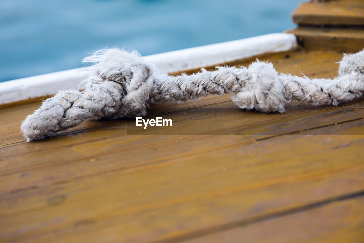 CLOSE-UP OF ROPE ON TABLE