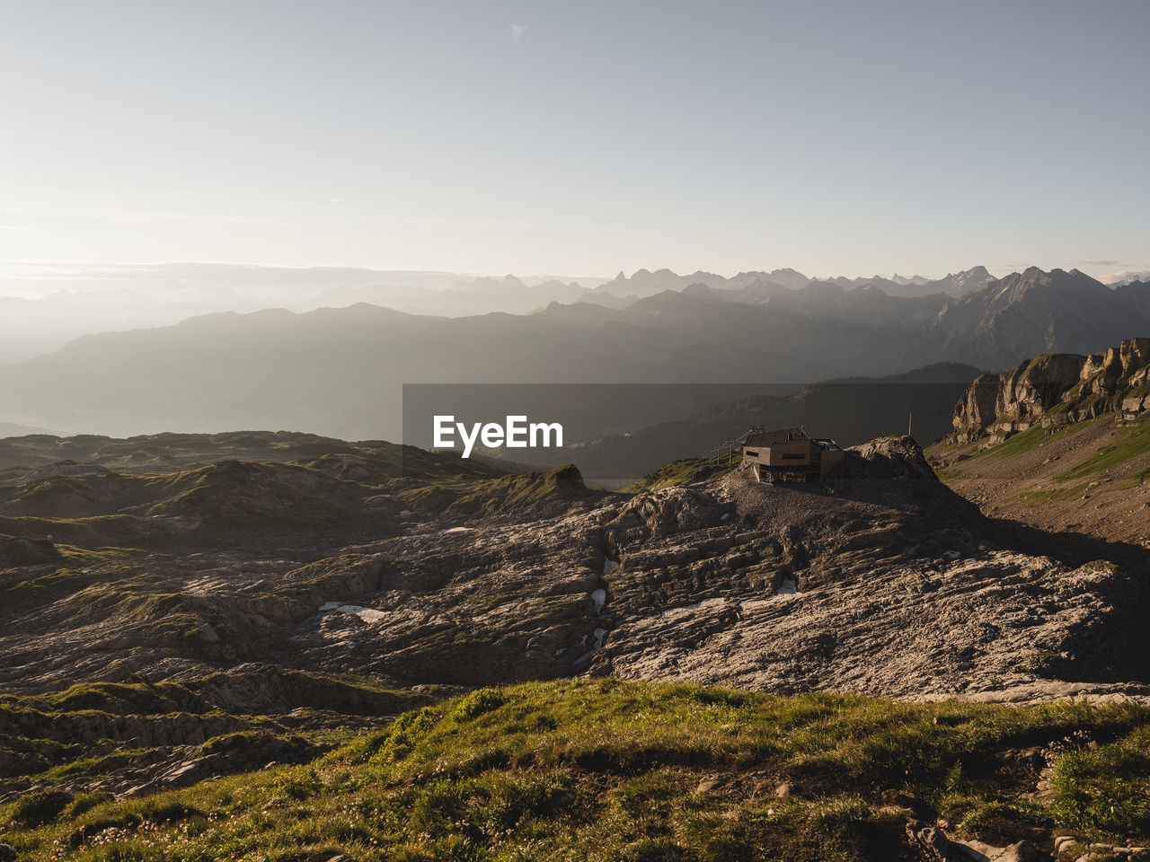 View of house on landscape against mountain range