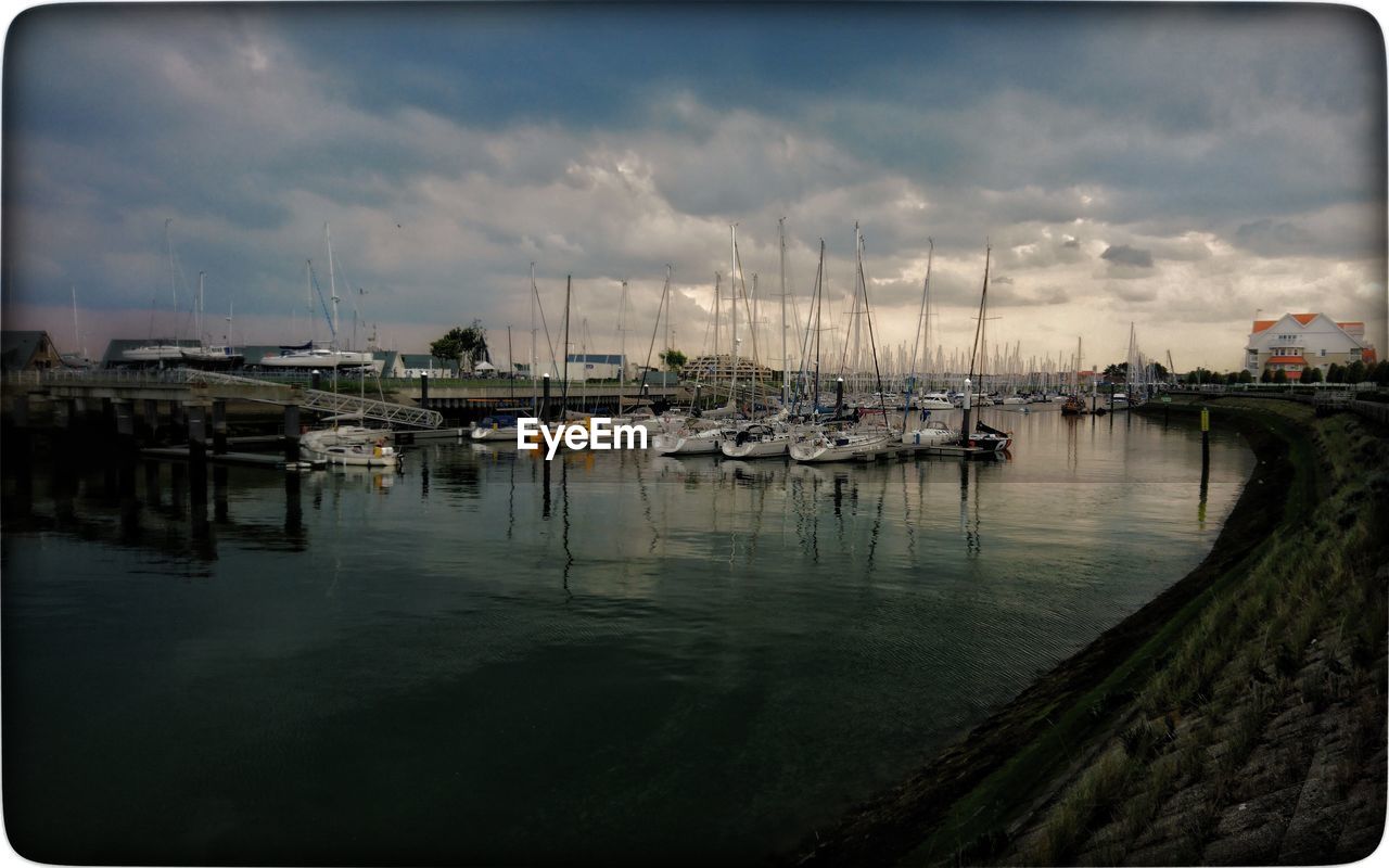 SAILBOATS MOORED IN MARINA