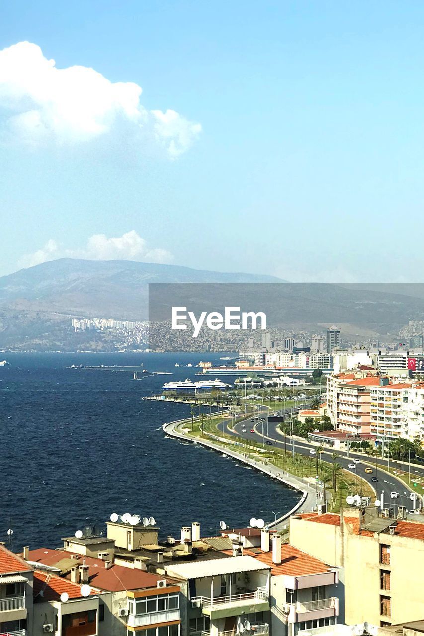 High angle view of buildings by sea against sky