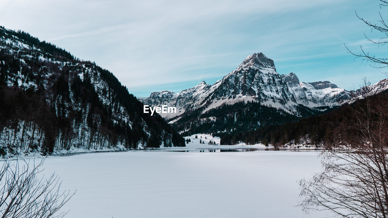 Scenic view of snowcapped mountains against sky