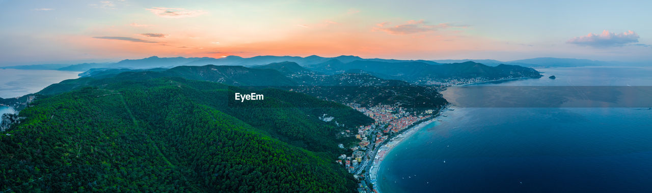 Panoramic shot of sea and mountains against sky