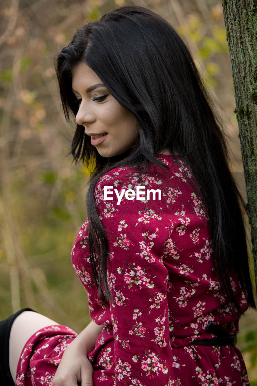 Woman sitting in forest