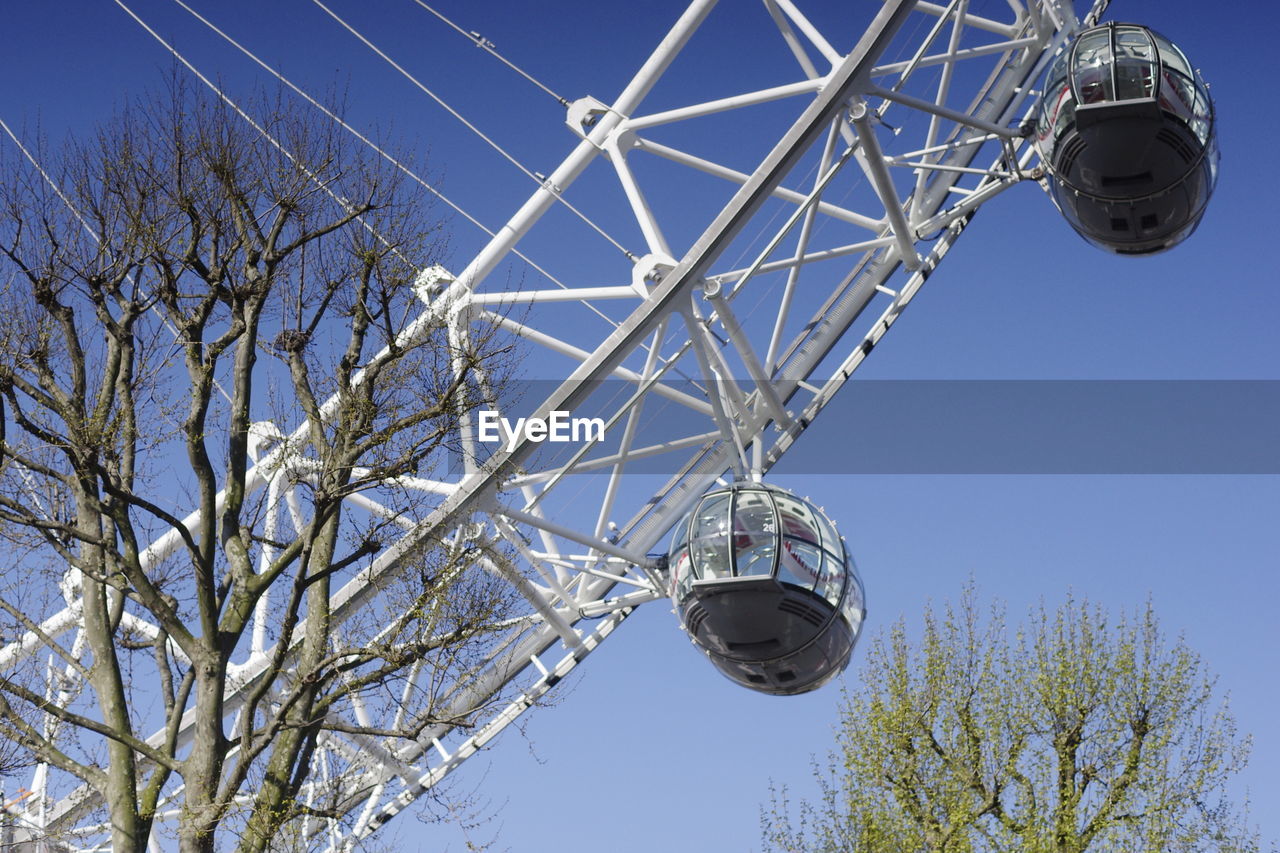 LOW ANGLE VIEW OF COMMUNICATIONS TOWER AGAINST SKY