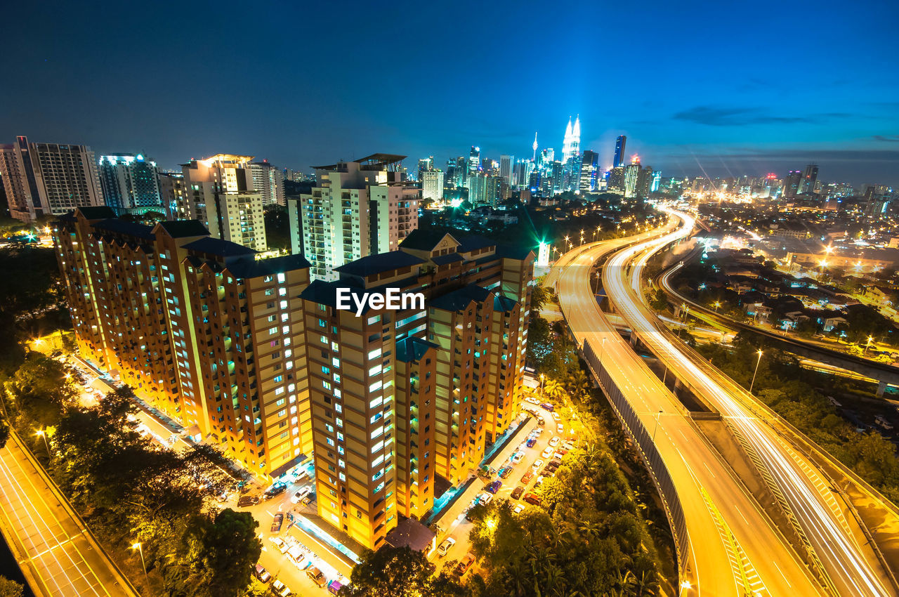 High angle view of city lit up at night