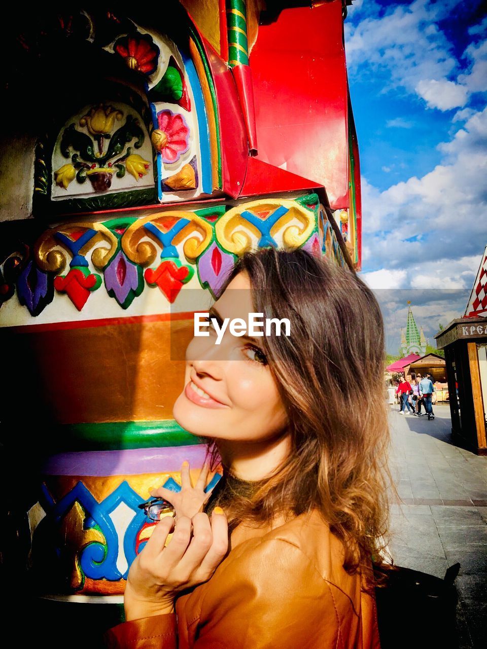 PORTRAIT OF SMILING YOUNG WOMAN WITH MULTI COLORED FACE