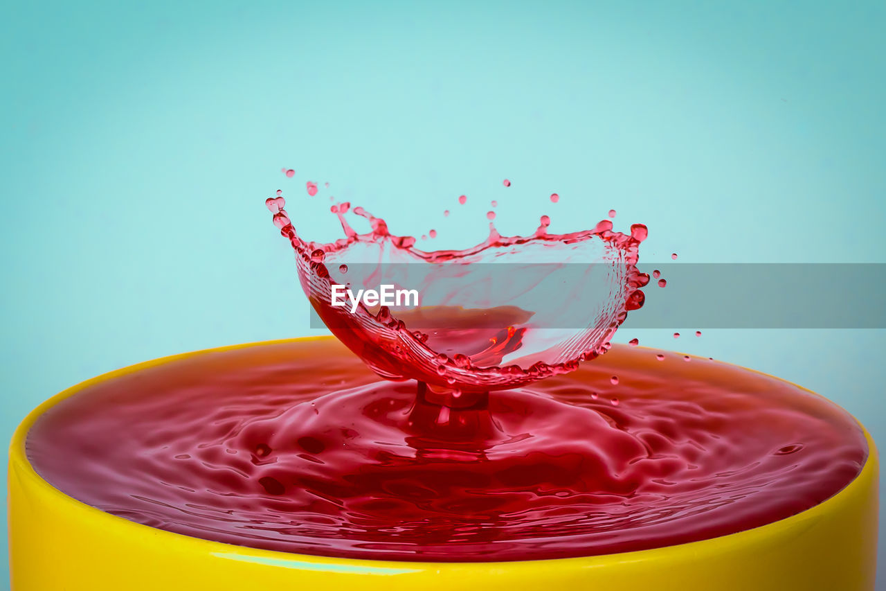 CLOSE-UP OF WATER SPLASHING IN GLASS