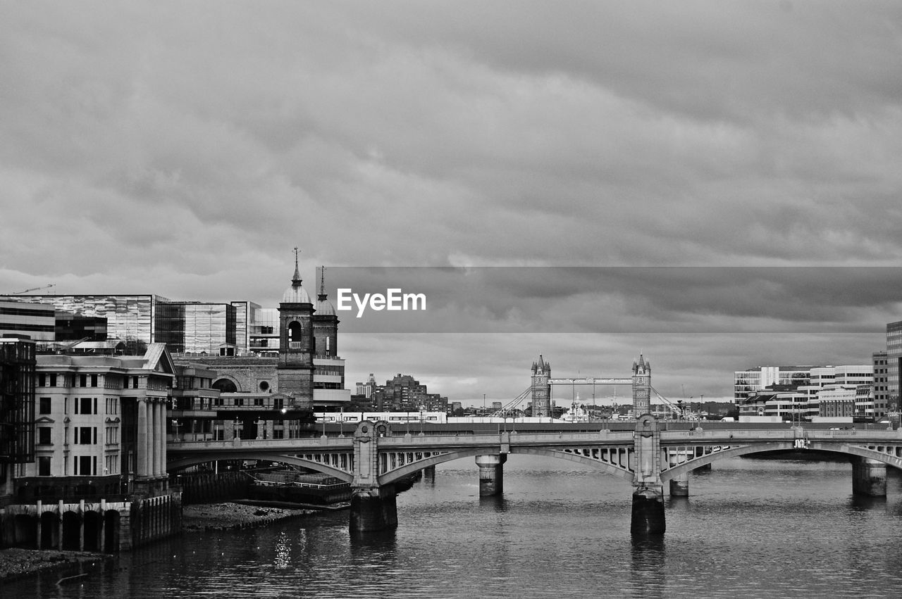 BRIDGE OVER RIVER AGAINST BUILDINGS