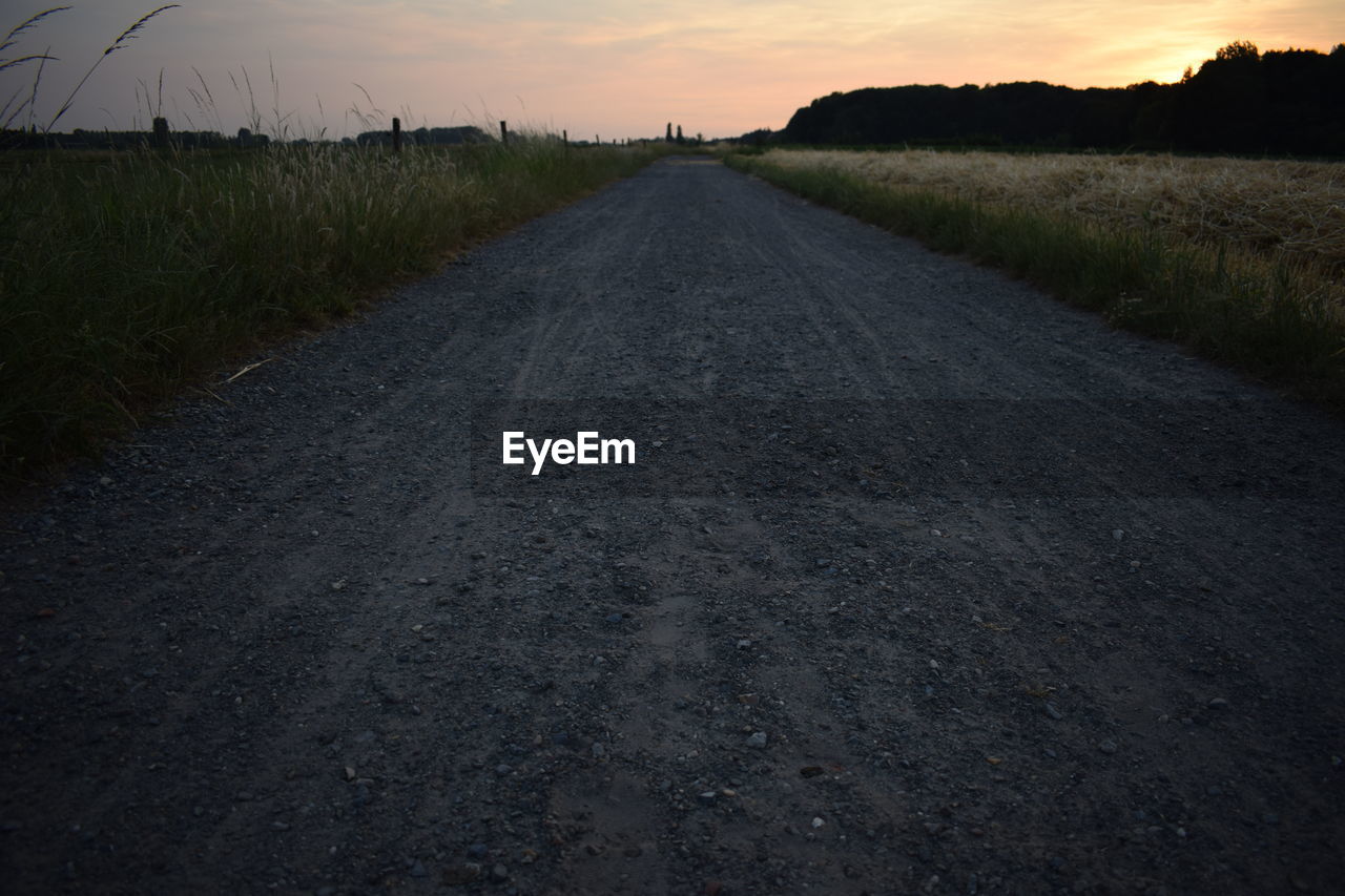 ROAD ON FIELD AGAINST SKY