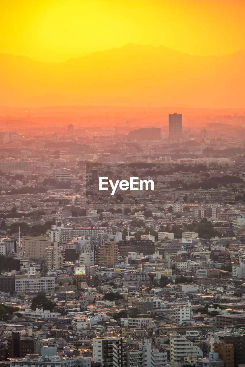 High angle view of buildings in city during sunset