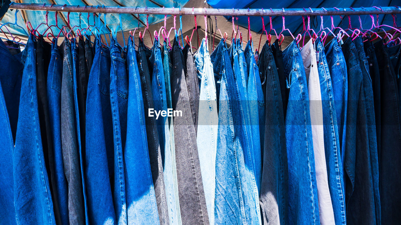 Close-up of clothes hanging on rack in store