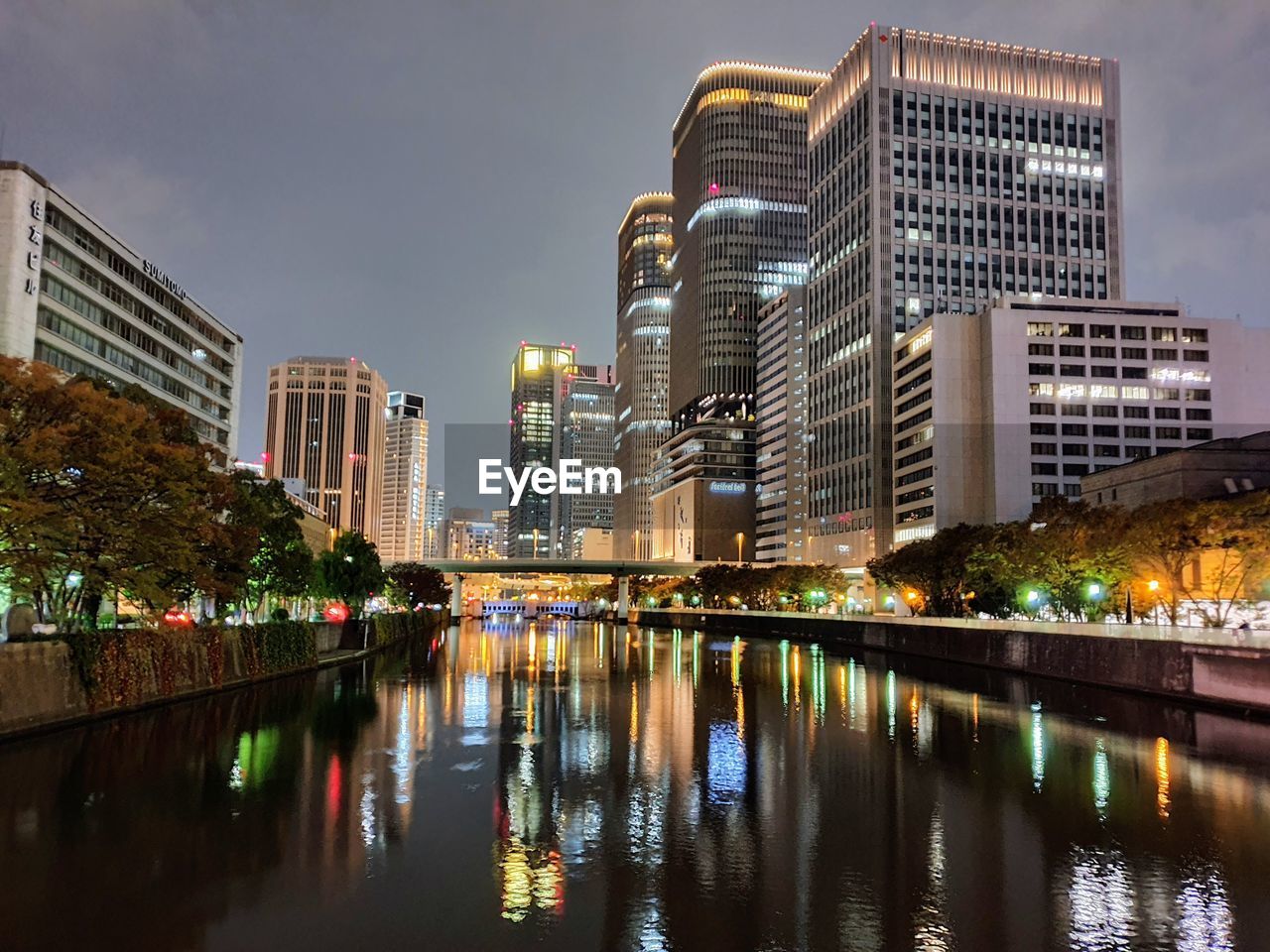 Reflection of illuminated buildings in river at night