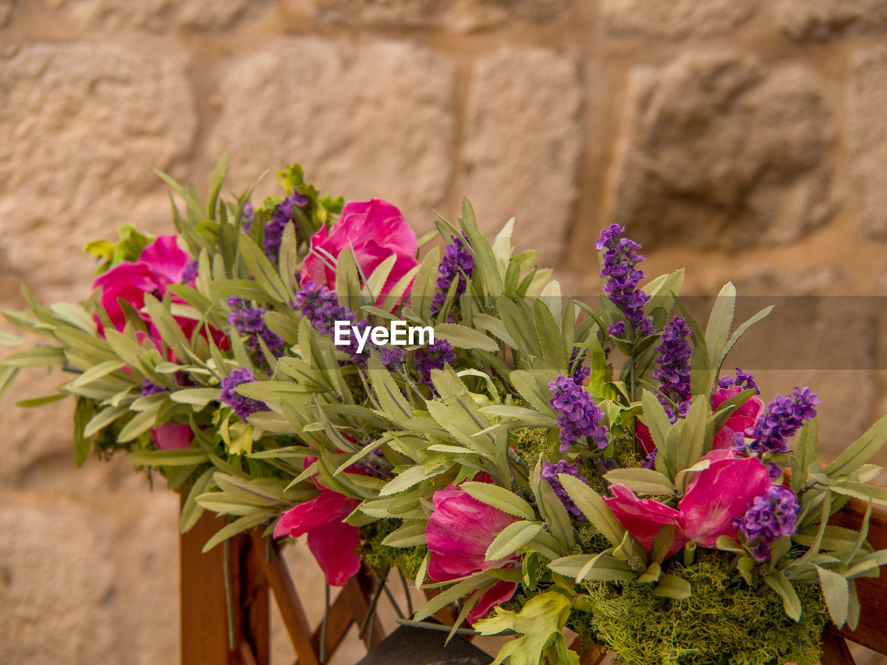 flower, plant, flowering plant, nature, freshness, beauty in nature, bouquet, floristry, no people, close-up, fragility, floral design, flower arrangement, pink, outdoors, growth, focus on foreground, wall - building feature, flower head, day, multi colored, arrangement, purple
