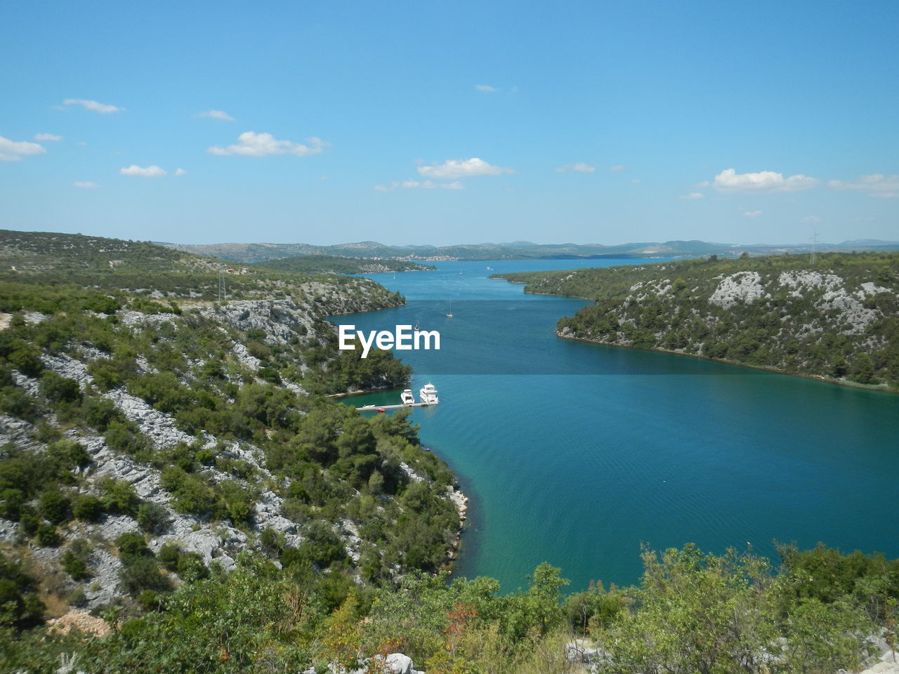 High angle view of trees on shore against sky