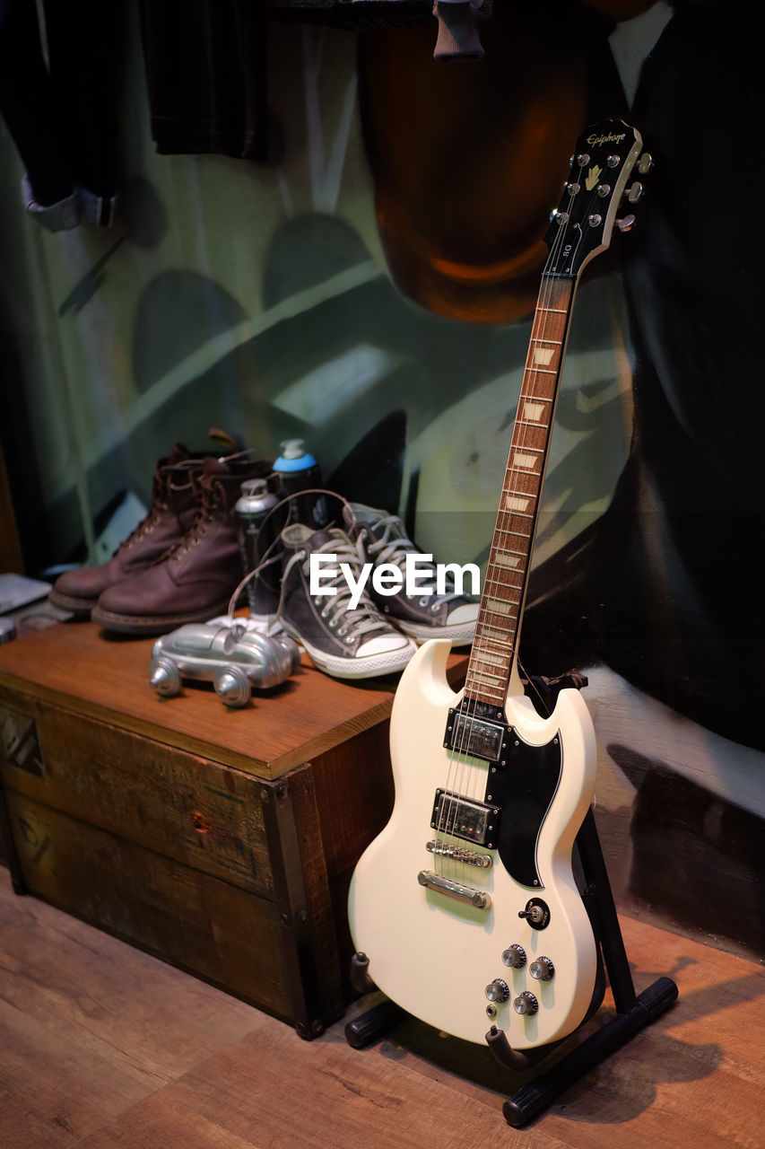 CLOSE-UP OF GUITAR ON TABLE