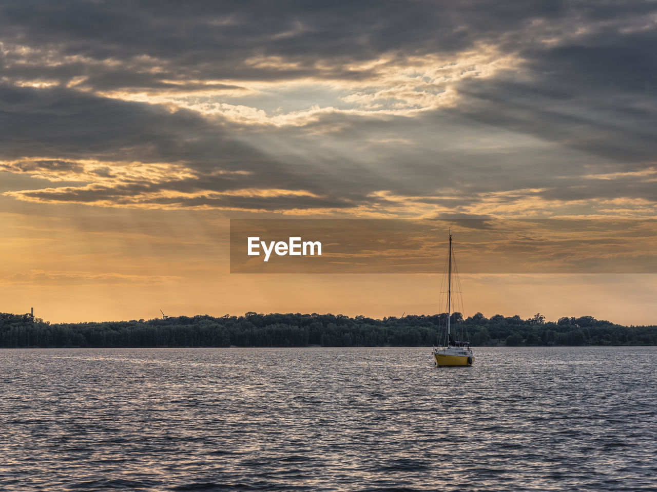 Rays of light on the cospudener see with sailboat