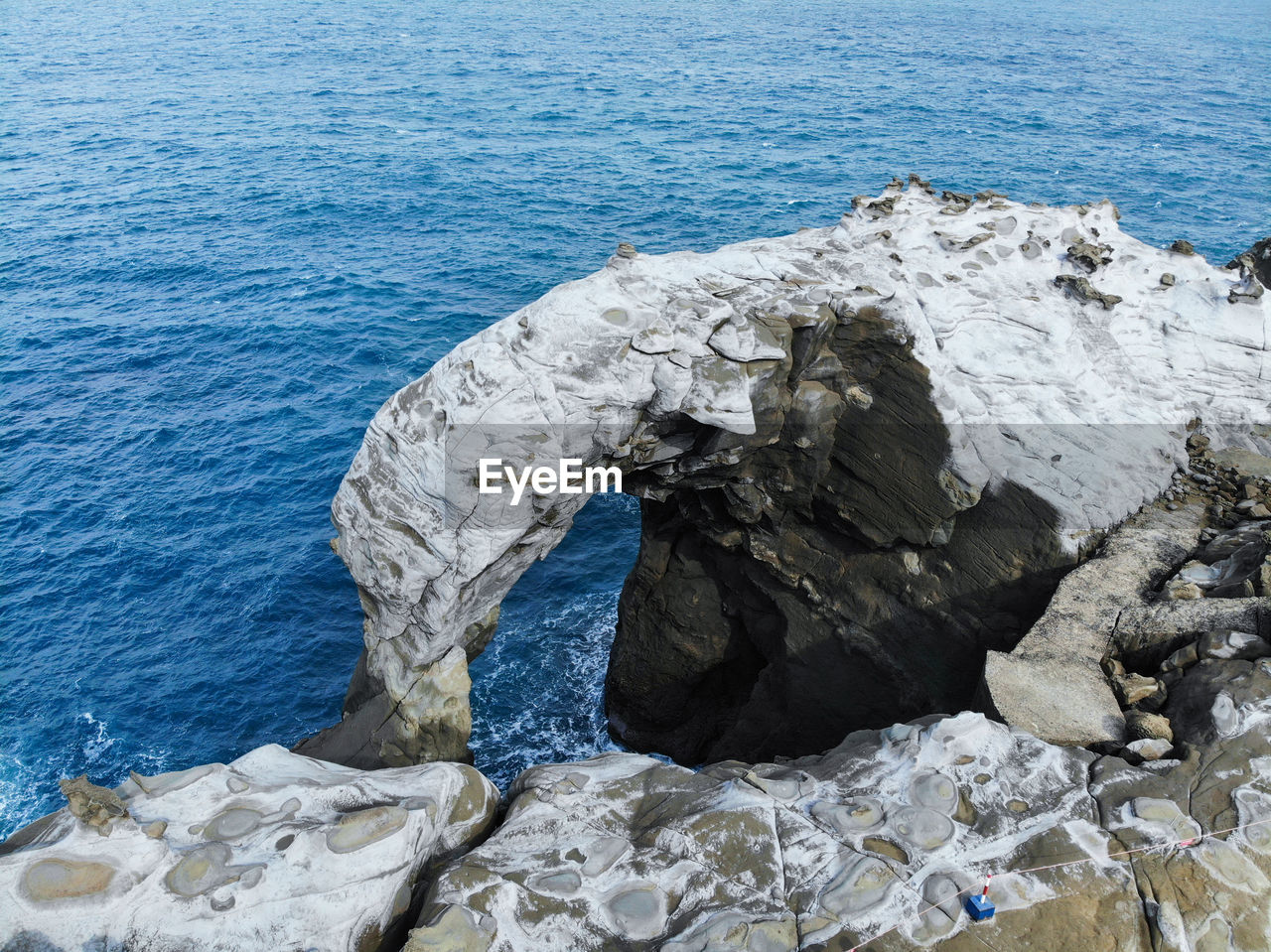 HIGH ANGLE VIEW OF ROCK FORMATIONS ON SHORE