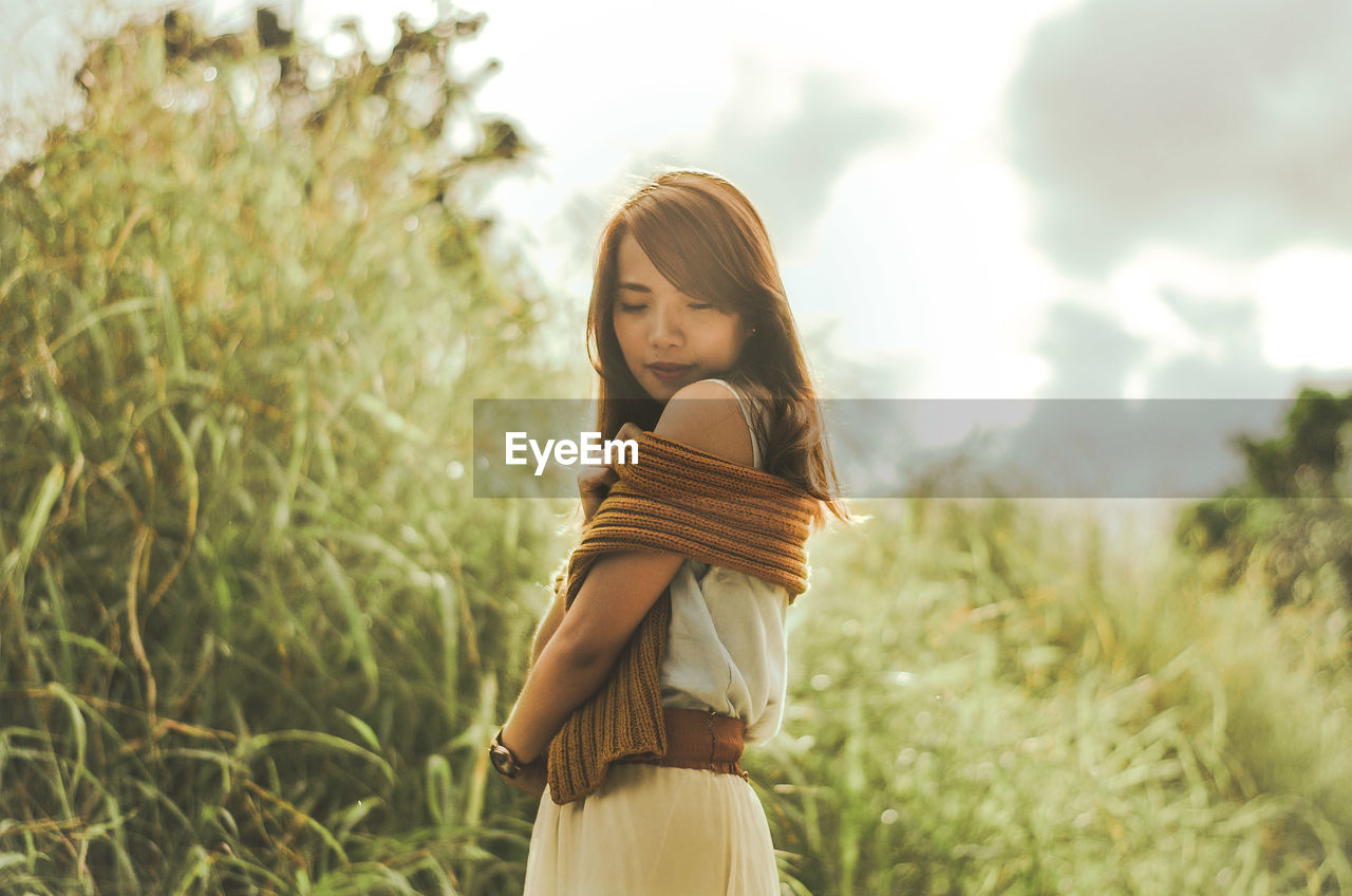 Portrait of young woman standing outdoors