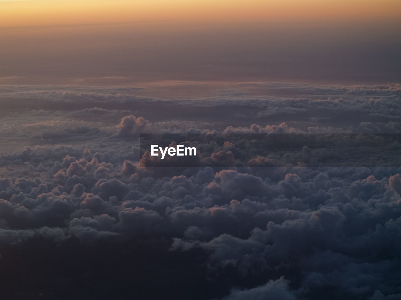 AERIAL VIEW OF CLOUDSCAPE AGAINST SKY AT SUNSET