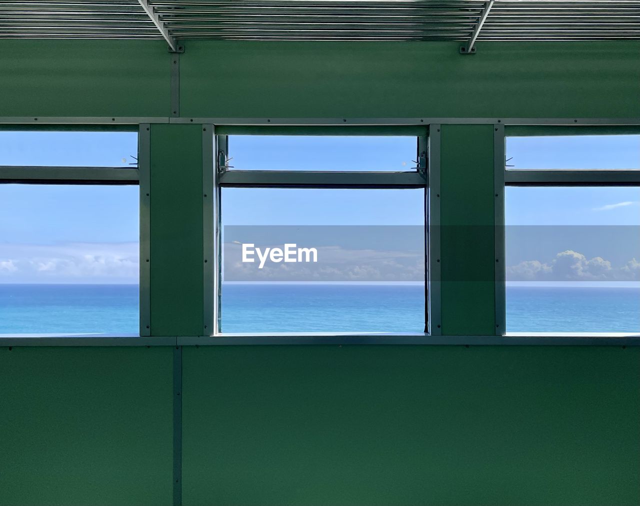 SEA AGAINST SKY SEEN THROUGH WINDOW