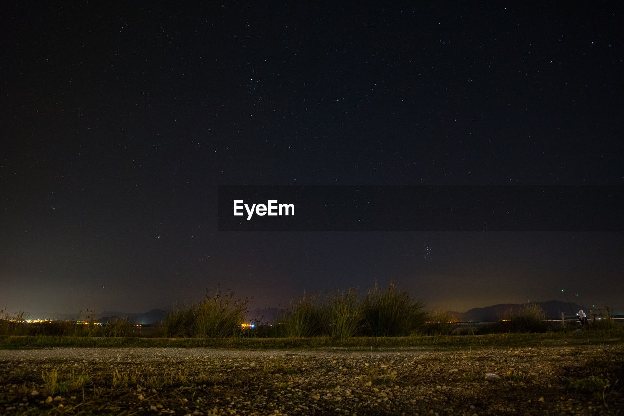 Scenic view of landscape against sky at night