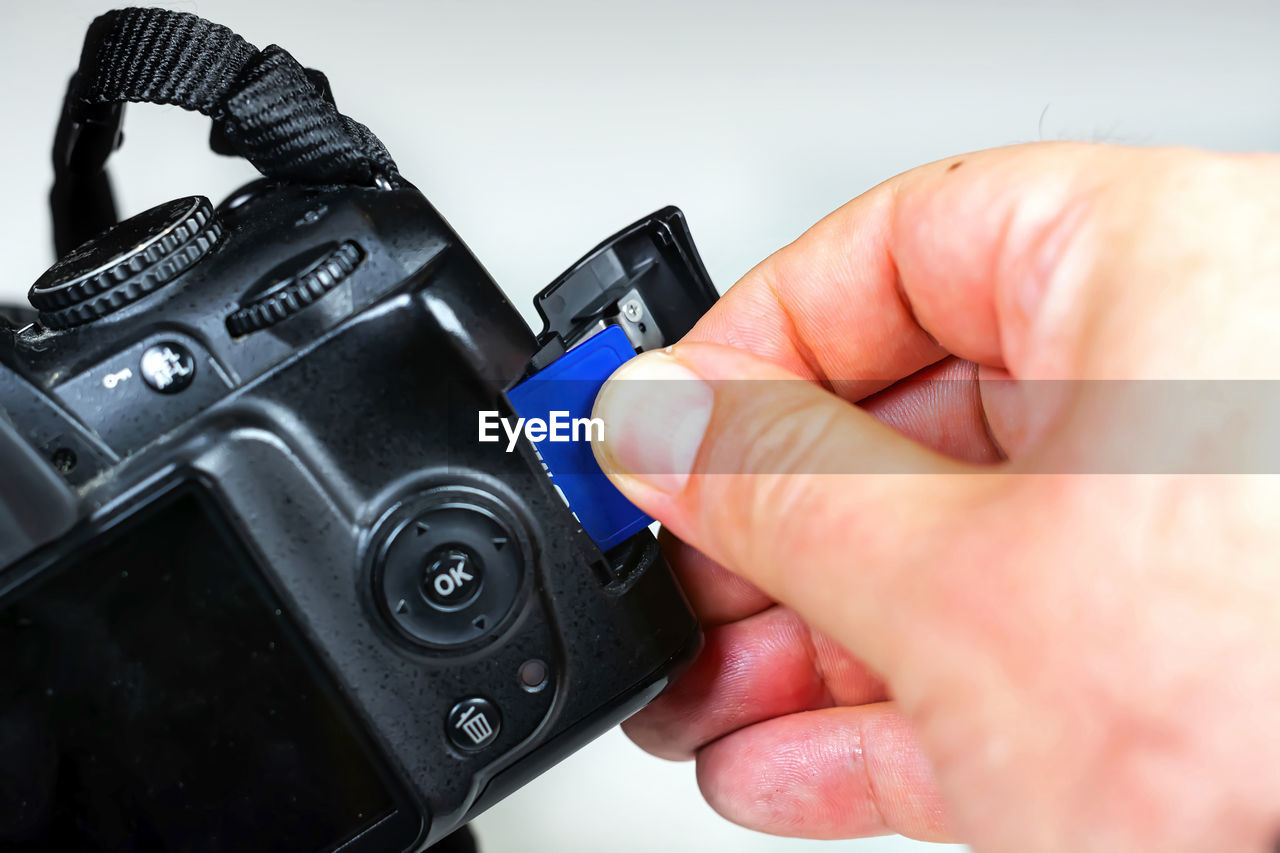 CLOSE-UP OF PERSON PHOTOGRAPHING WITH CAMERA