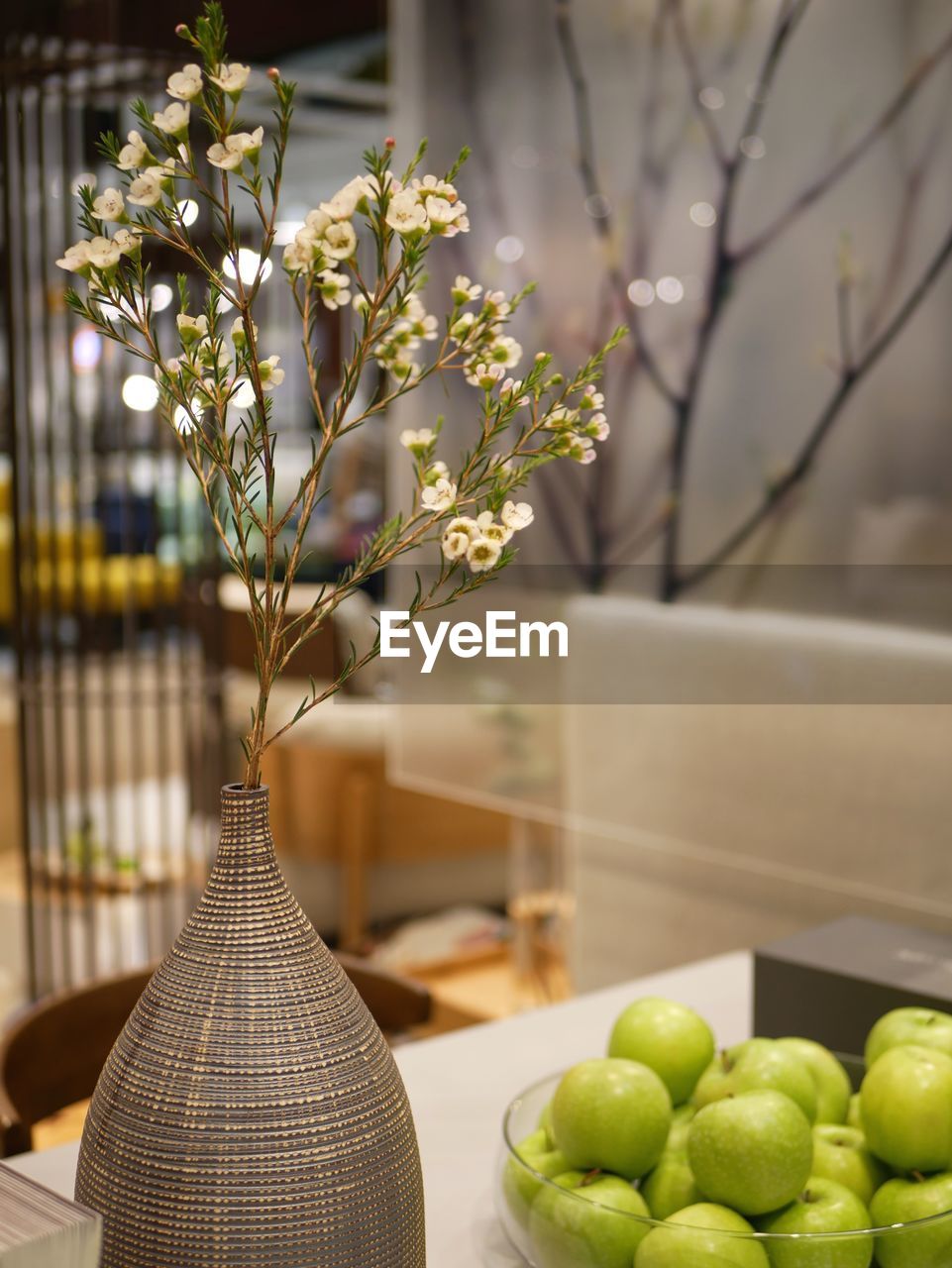 Close-up of apples in vase on table