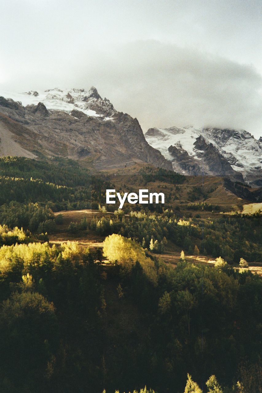 SCENIC VIEW OF LANDSCAPE AND MOUNTAIN RANGE
