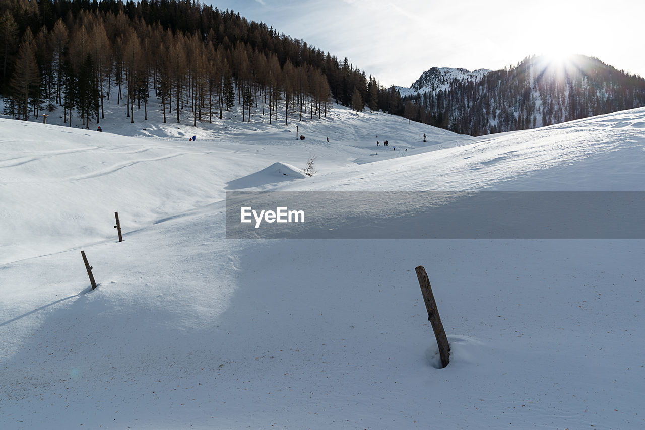 Scenic view of snow covered field against mountain