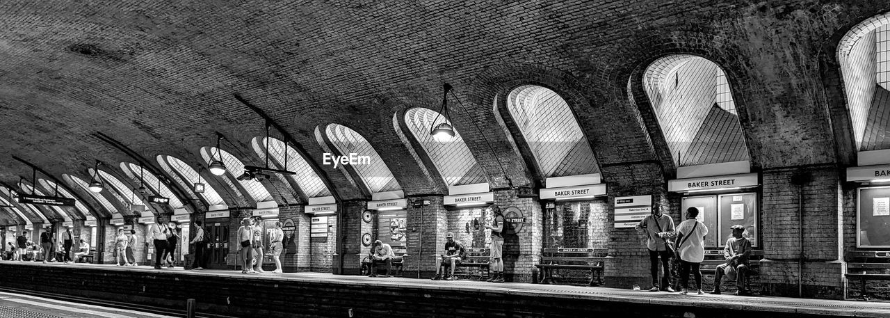 architecture, black and white, rail transportation, monochrome, built structure, transportation, arch, railroad station, monochrome photography, public transportation, track, transport, railroad track, indoors, mode of transportation, railroad station platform, travel, urban area, day, train station, ceiling, black, building, public transport, train, no people, metro station, subway, architectural column