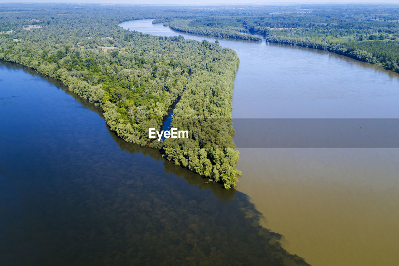 HIGH ANGLE VIEW OF RIVER BY TREE AGAINST SKY