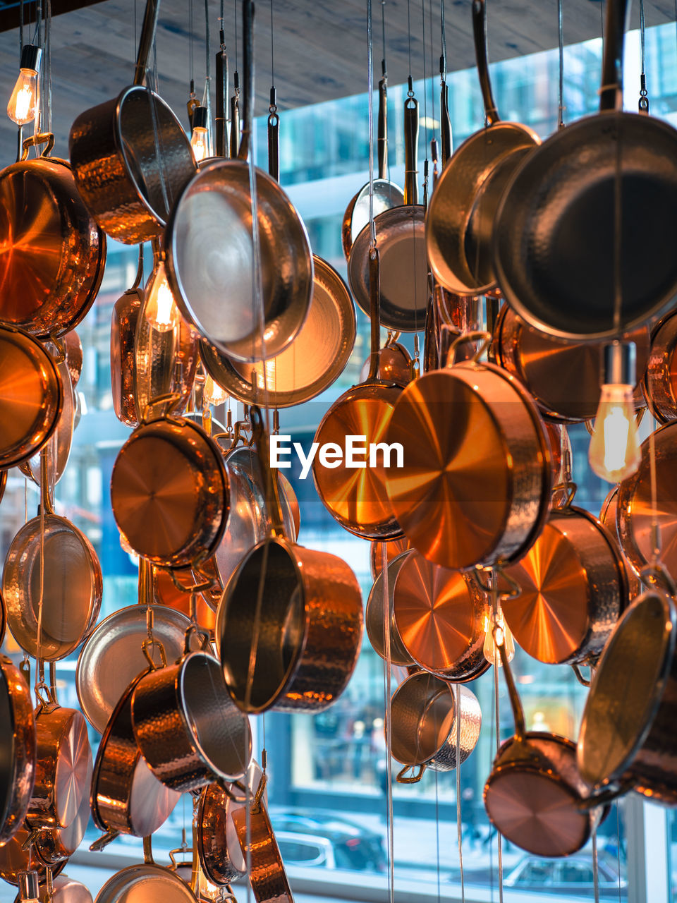 Low angle view of cooking utensil for sale at market stall